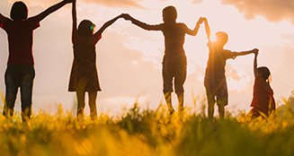 Group holding hands in a field